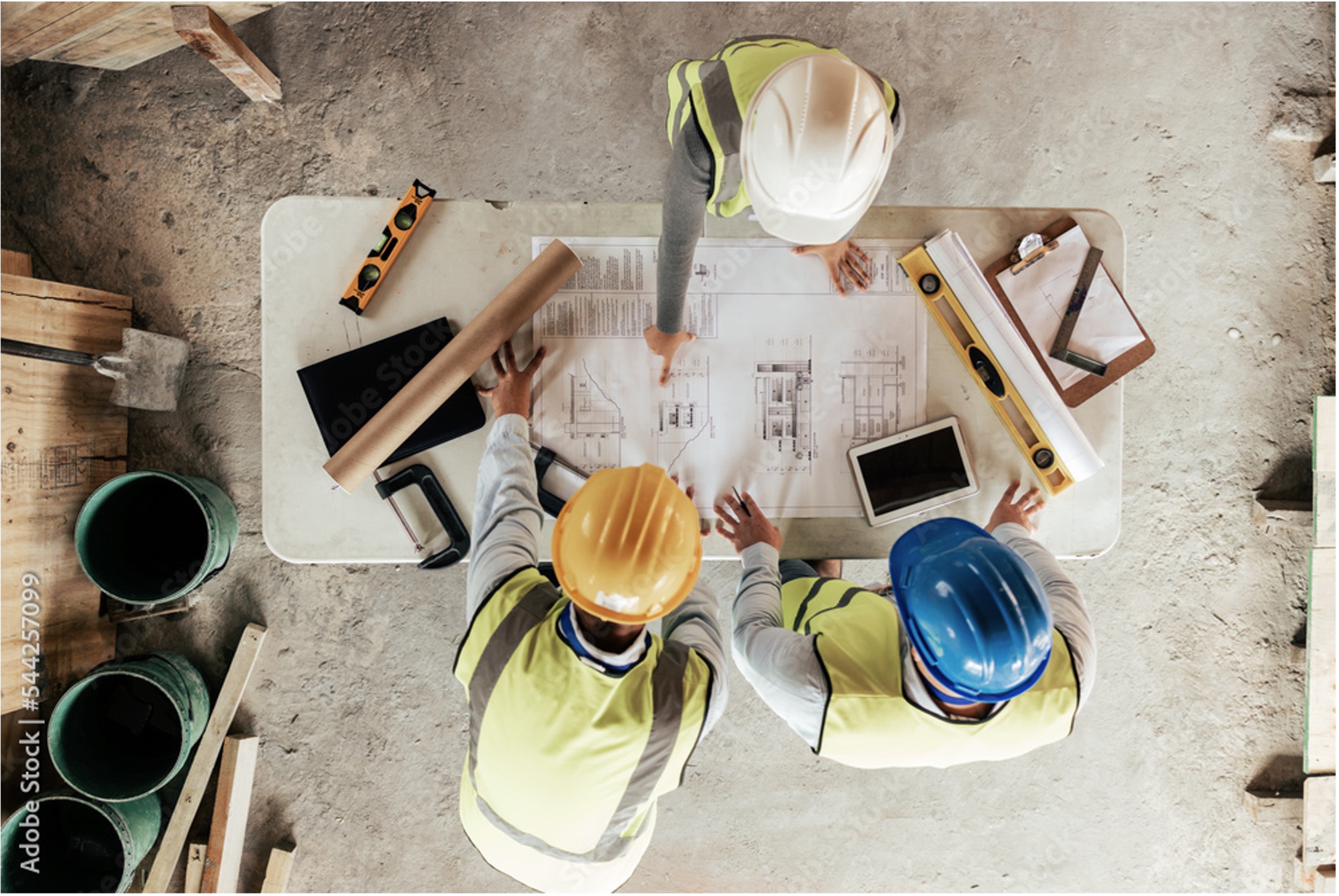 Siam & Partners project team reviewing construction blueprints